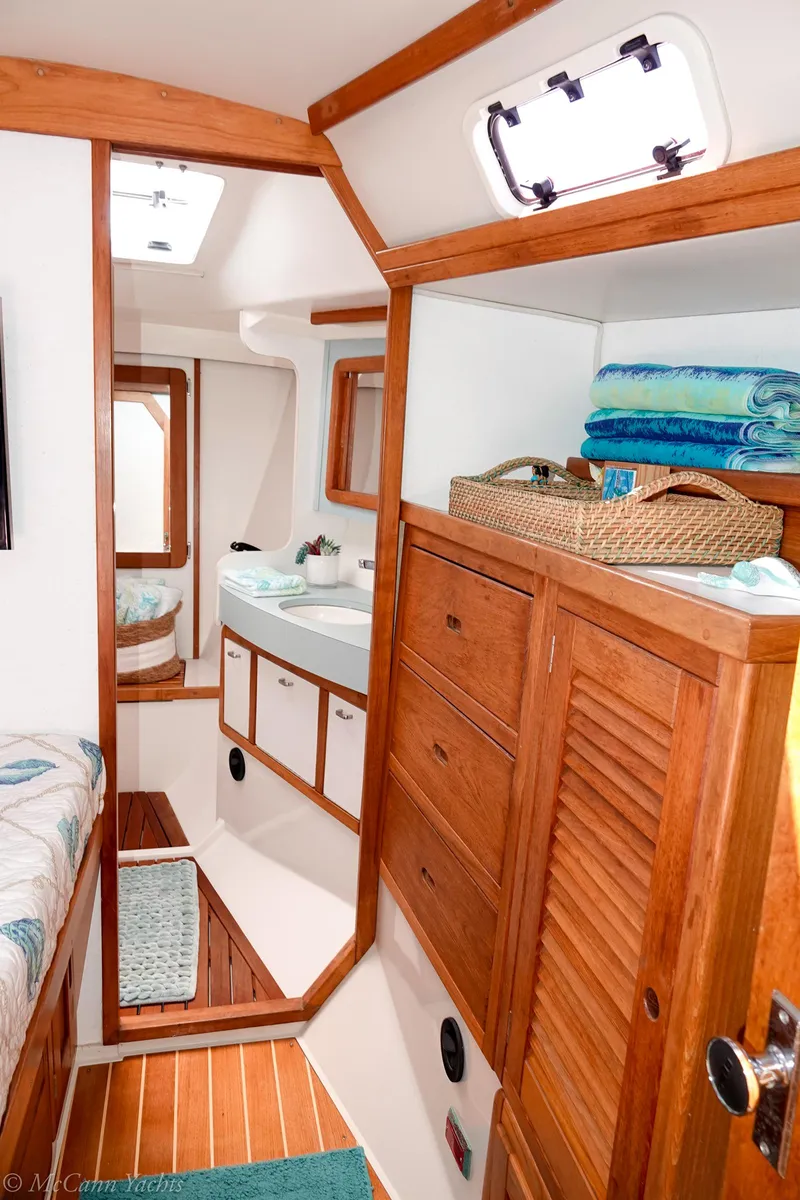 Slide: The Image of Interior of a 1991 Catalina 42 sailboat with wooden cabinetry and nautical decor. - 29