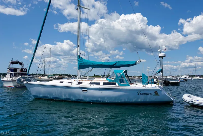 Slide: The Image of Catalina 42 sailboat from 1991 on water, clear sky, other boats in background. - 3