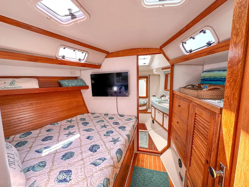 Slide: The Image of Cozy cabin interior of a 1991 Catalina 42 sailboat with wood accents and nautical decor. - 31