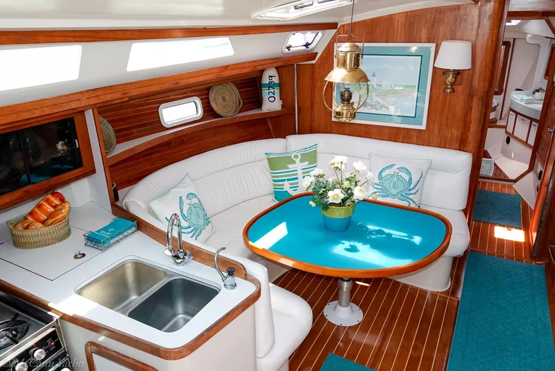 Slide: The Image of Interior of a 1991 Catalina 42 sailboat with elegant wood finish and cozy seating area. - 40