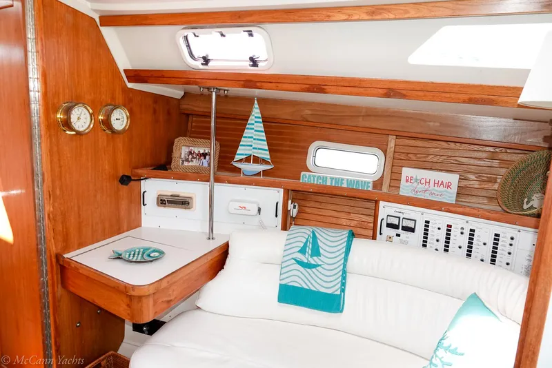 Slide: The Image of Interior of a 1991 Catalina 42 yacht with nautical decor and white seating. - 45