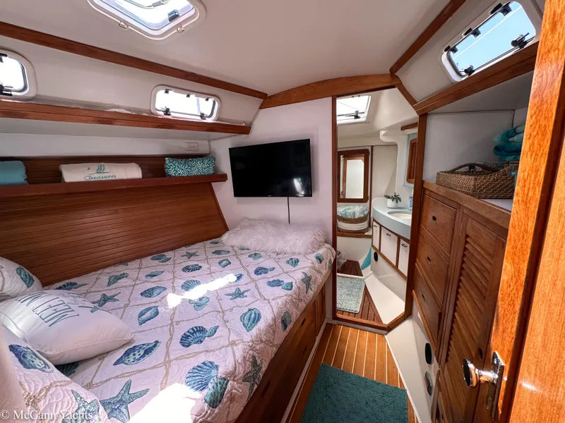 Slide: The Image of Cozy cabin interior of 1991 Catalina 42 sailboat with bed, TV, and bathroom. - 47
