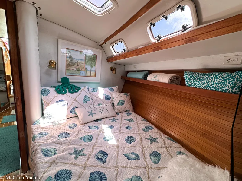 Slide: The Image of Cozy cabin interior of 1991 Catalina 42 yacht with nautical-themed bedding. - 49