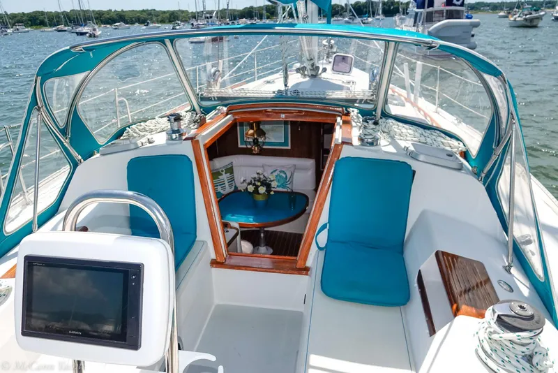 Slide: The Image of 1991 Catalina 42 sailboat cockpit with blue cushions and navigation equipment. - 6