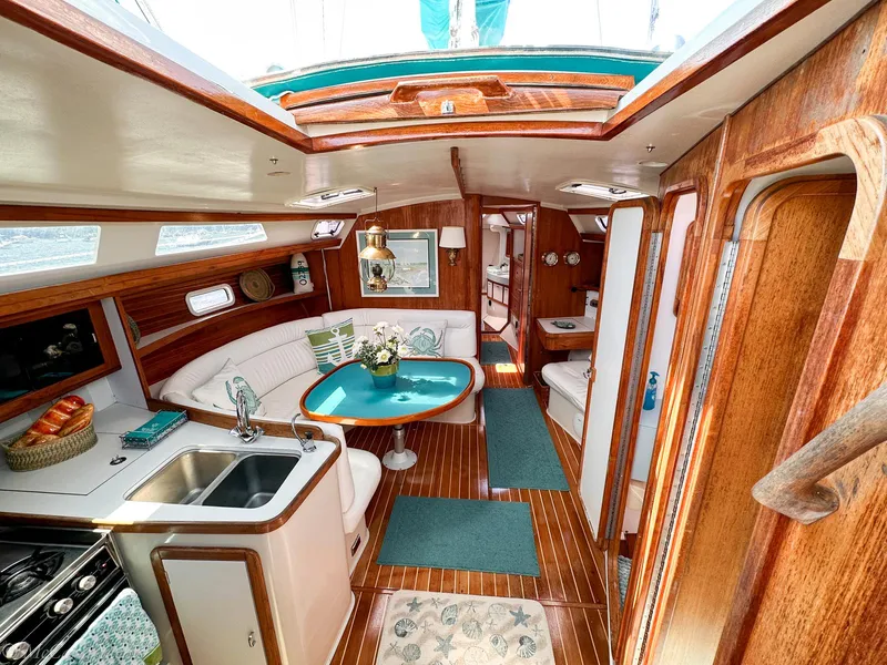 Slide: The Image of Interior of a 1991 Catalina 42 sailboat with wood finish and cozy seating area. - 7