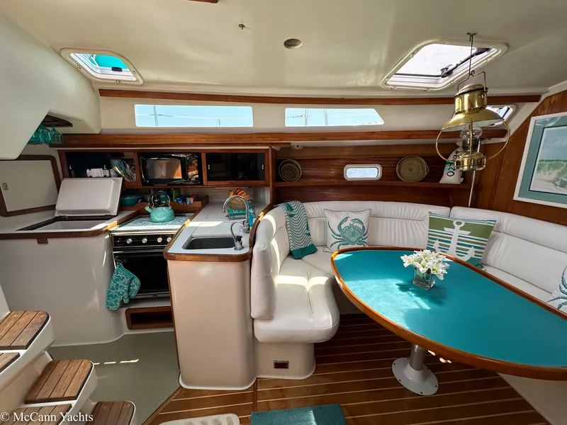 Slide: The Image of Luxurious interior of a 1991 Catalina 42 yacht with modern kitchen and cozy seating area. - 9