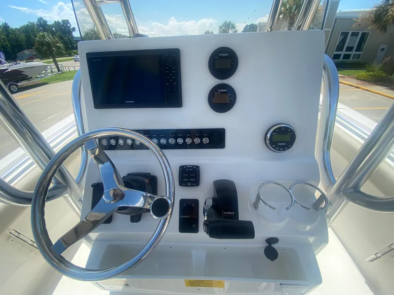 Slide: The Image of 2024 Key West 239 FS boat console with steering wheel, gauges, and navigation system. - 14