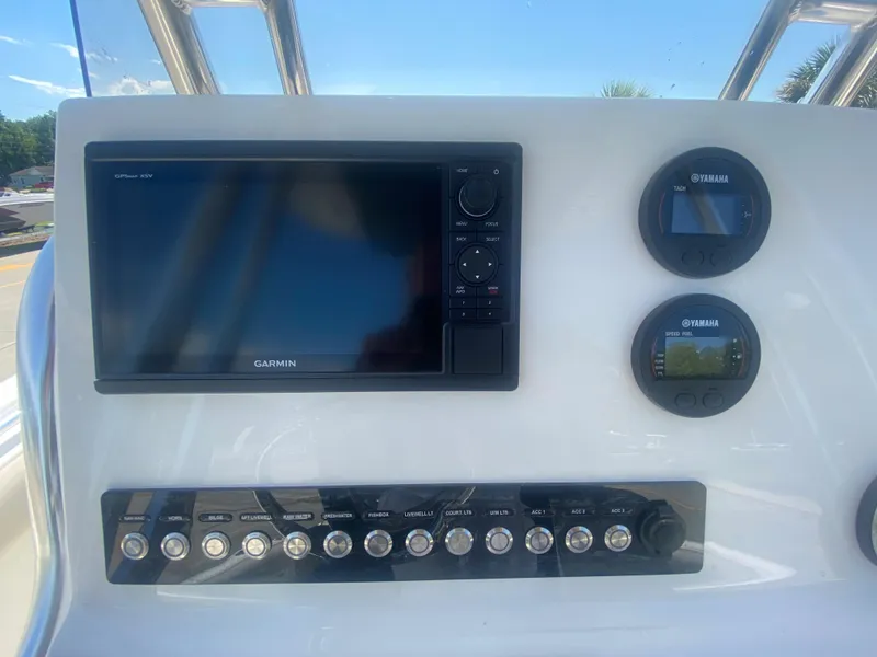 Slide: The Image of 2024 Key West 239 FS boat dashboard with Garmin and Yamaha displays. - 15