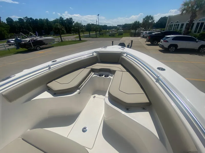 Slide: The Image of 2024 Key West 239 FS boat with spacious bow seating in a parking lot. - 19