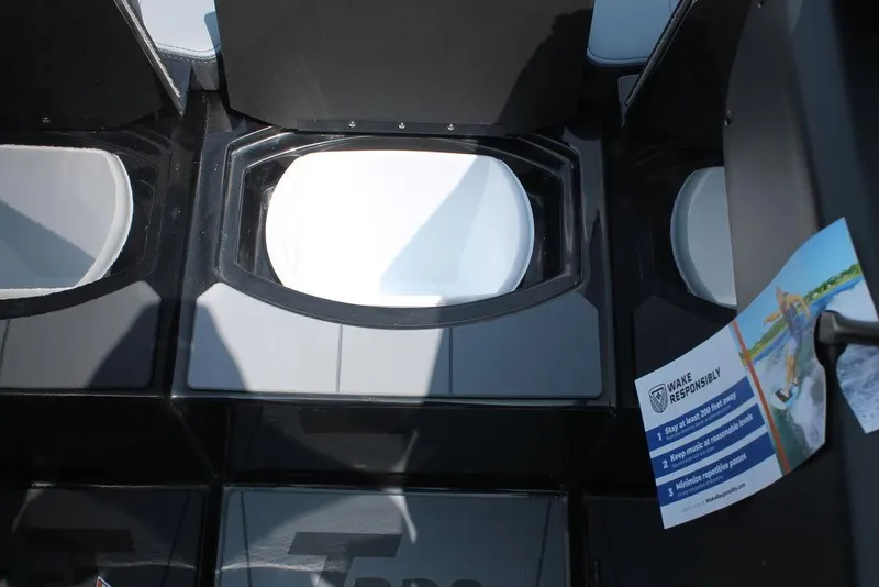 Slide: The Image of 2024 Axis T220 boat storage compartments with safety instructions. - 13