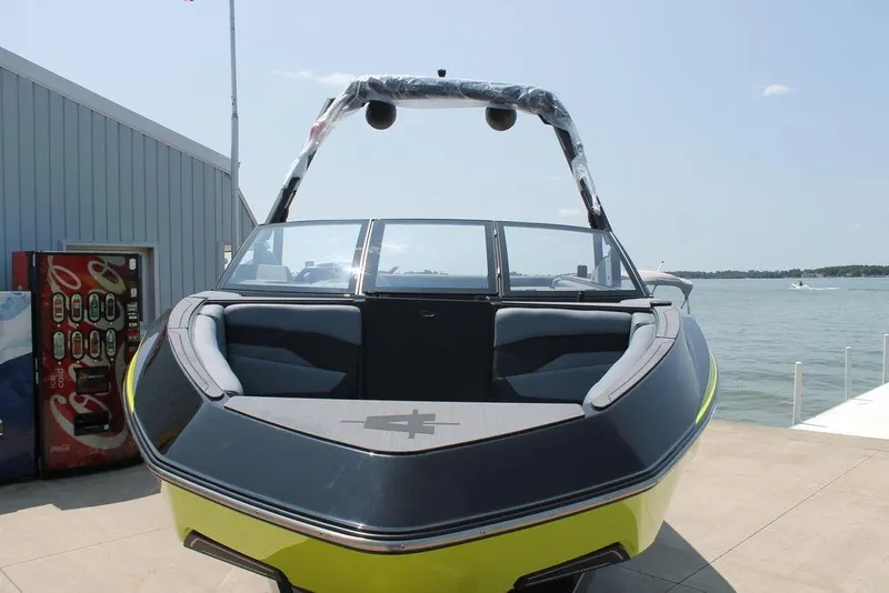 Slide: The Image of 2024 Axis T220 boat docked by a lake, front view. - 5