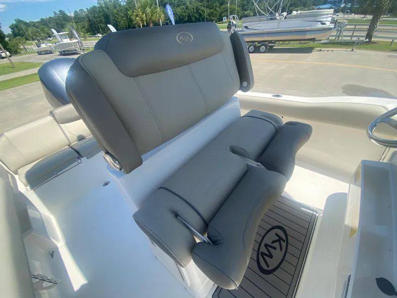 Slide: The Image of 2024 Key West 239 FS boat interior with cushioned seating and KW logo mat. - 13