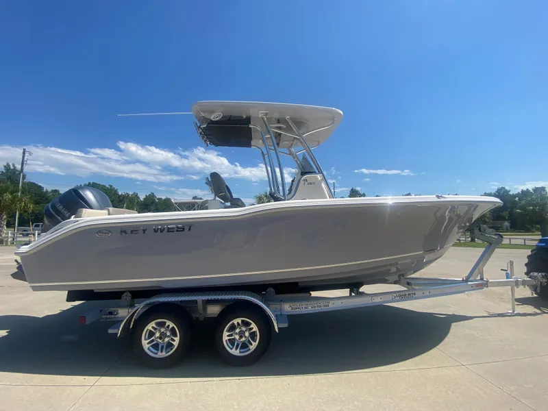 Slide: The Image of 2024 Key West 239 FS boat on a trailer under a clear blue sky. - 2