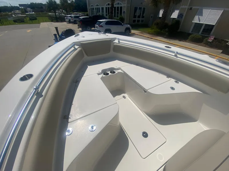 Slide: The Image of 2024 Key West 239 FS boat bow seating area with storage compartments. - 25