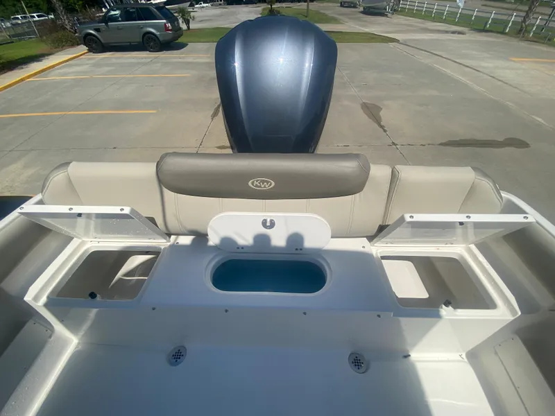 Slide: The Image of 2024 Key West 239 FS boat rear seating and storage compartments. - 8