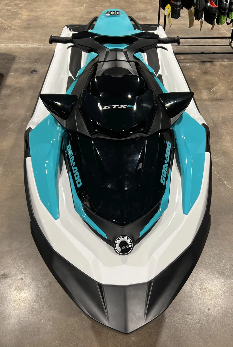Slide: The Image of 2022 Sea-Doo GTX PRO 130 jet ski in showroom. - 2