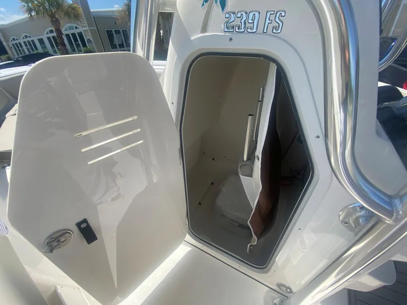 Slide: The Image of 2024 Key West 239 FS boat storage compartment with open door. - 21