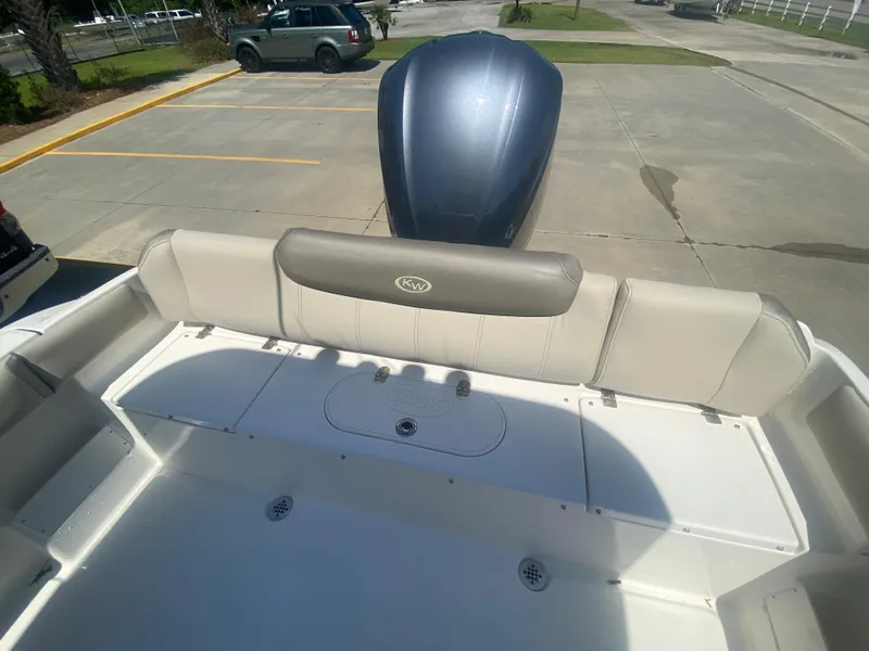 Slide: The Image of 2024 Key West 239 FS boat rear seating and engine view in parking lot. - 7
