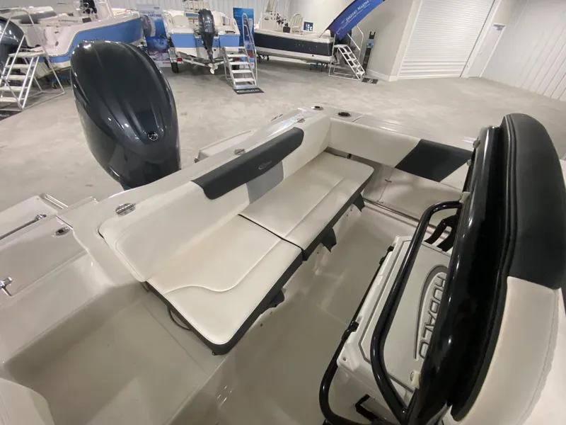 Slide: The Image of 2024 Robalo 202 EXPLORER boat interior with seating and outboard motor in showroom. - 6