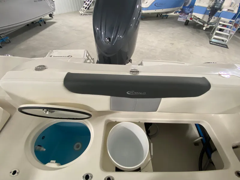 Slide: The Image of 2024 Robalo 202 EXPLORER boat interior with storage compartments and engine. - 7