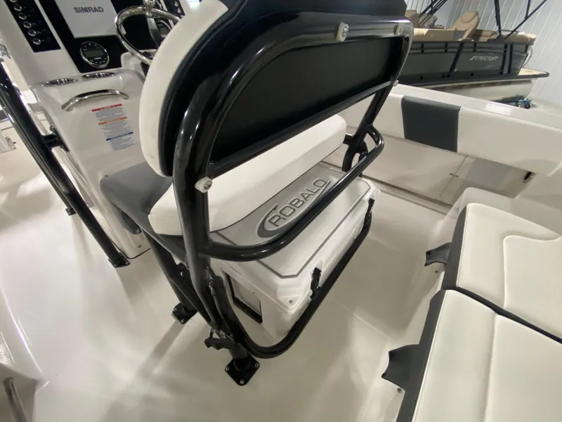 Slide: The Image of 2024 Robalo 202 EXPLORER boat interior with seating and storage. - 9