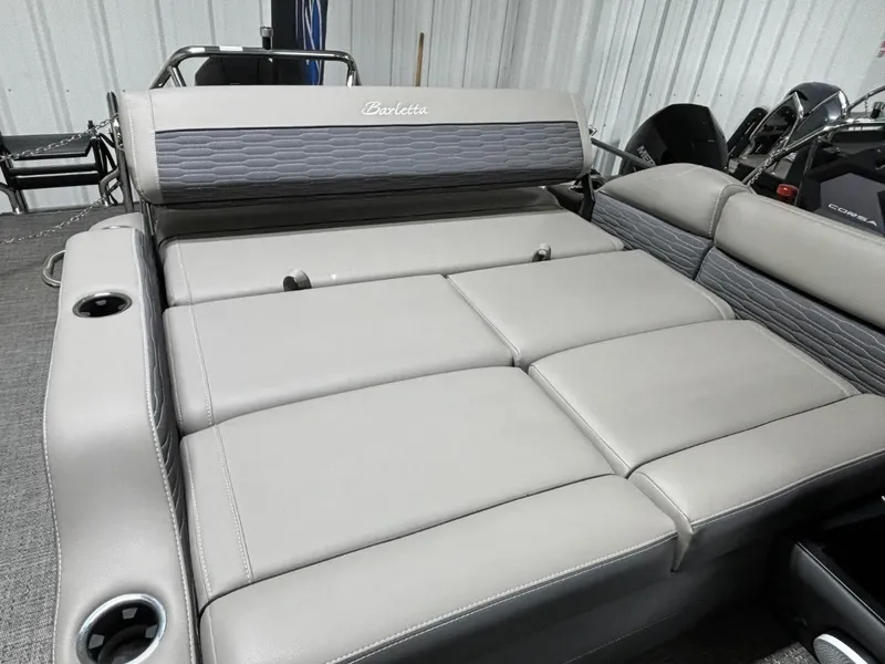 Slide: The Image of 2024 Barletta Corsa 23U boat interior with gray cushioned seating and cup holders. - 4