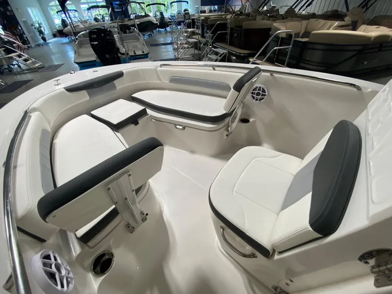 Slide: The Image of 2024 Robalo 202 EXPLORER boat interior with white and black seating. - 14