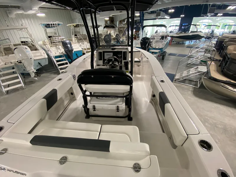 Slide: The Image of 2024 Robalo 202 EXPLORER boat interior in showroom, featuring seating and console. - 5