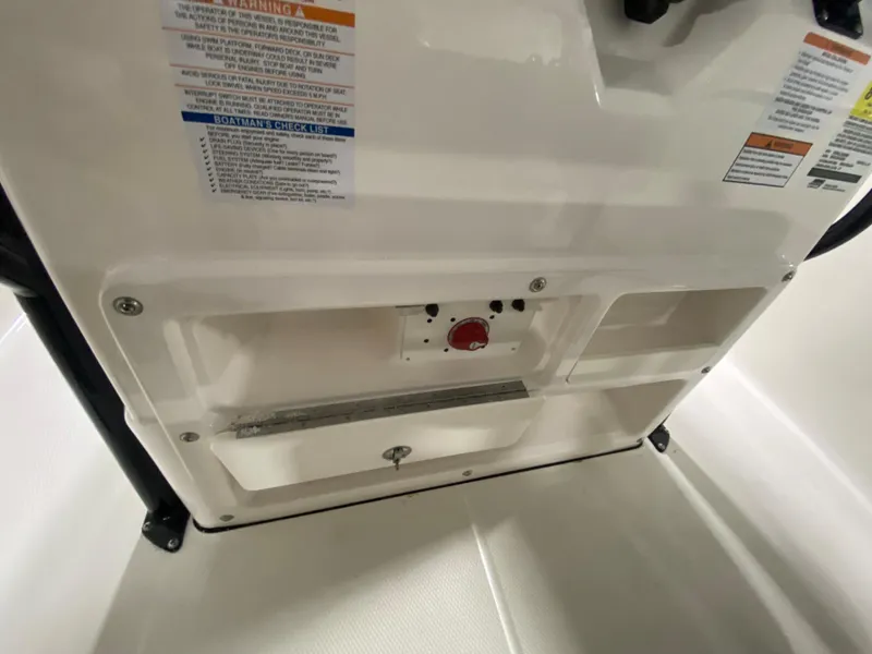 Slide: The Image of 2024 Robalo 202 EXPLORER boat interior control panel and storage compartments. - 13