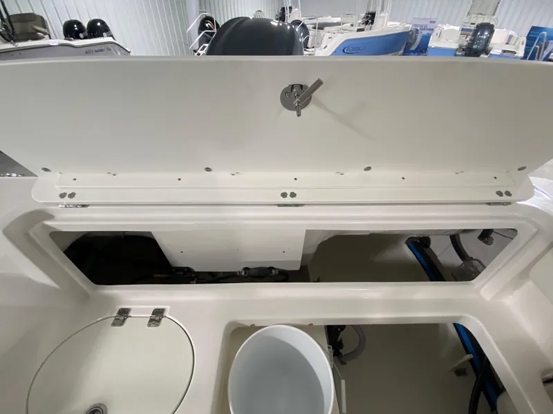 Slide: The Image of 2024 Robalo 202 EXPLORER boat interior storage compartment with open hatch. - 8