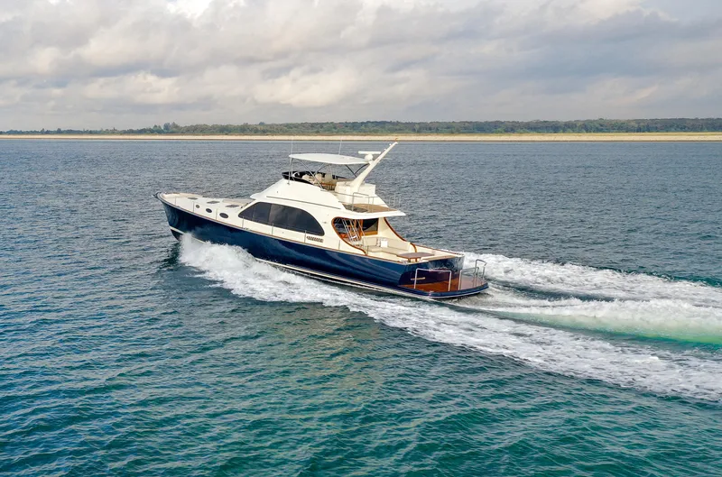 Slide: The Image of 2021 Palm Beach Motor Yachts PB65 cruising on open water, showcasing sleek design and luxury. - 0