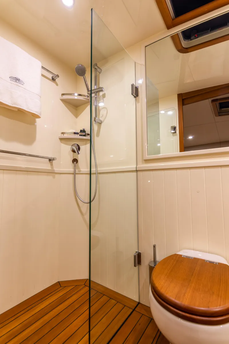 Slide: The Image of Luxurious bathroom in 2021 Palm Beach Motor Yachts PB65, featuring wood accents and modern fixtures. - 26