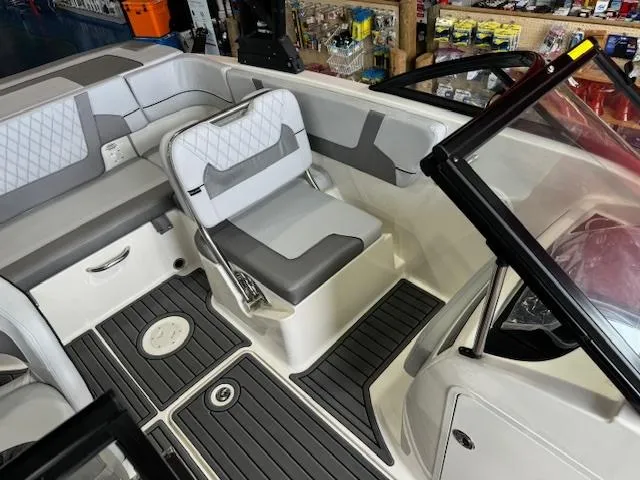 Slide: The Image of 2024 Bayliner VR5 boat interior with gray and white seating and black flooring. - 4