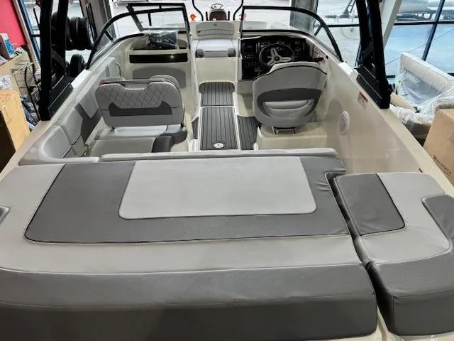 Slide: The Image of 2024 Bayliner VR5 boat interior with gray and white seating and modern dashboard. - 7