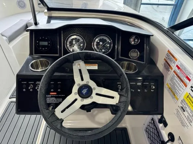 Slide: The Image of 2024 Bayliner VR5 boat dashboard with steering wheel and instrument panel. - 8