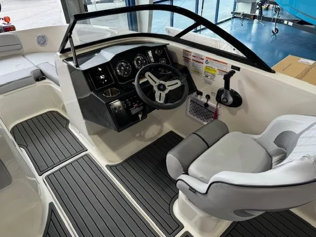 Slide: The Image of 2024 Bayliner VR5 boat interior with steering wheel and seating. - 9