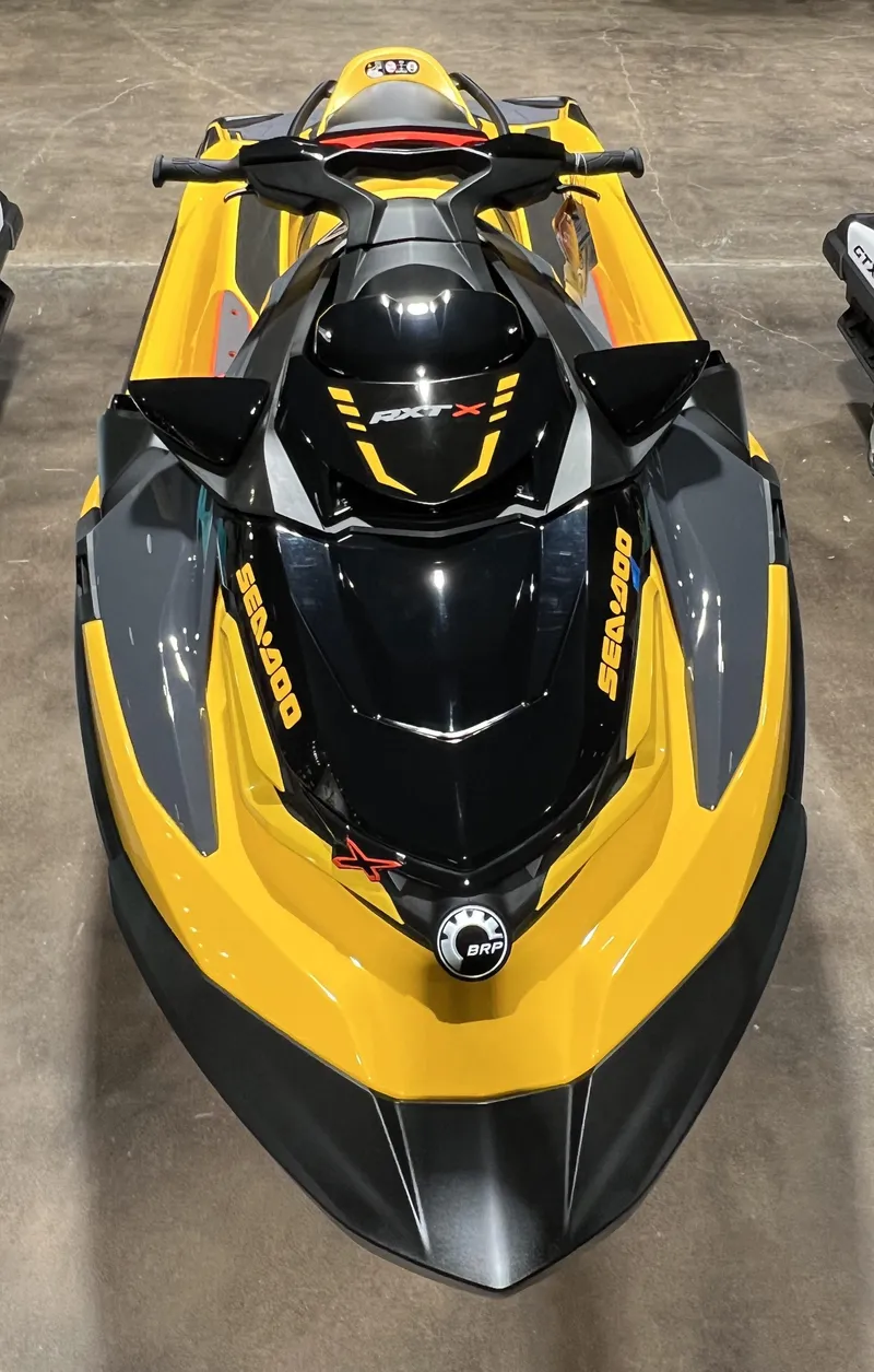 Slide: The Image of 2023 Sea-Doo RXT X 300 jet ski, yellow and black, top view. - 3
