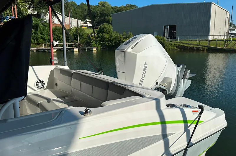 Slide: The Image of 2022 Tahoe 2150 CC boat with Mercury outboard engine docked by a lake. - 10