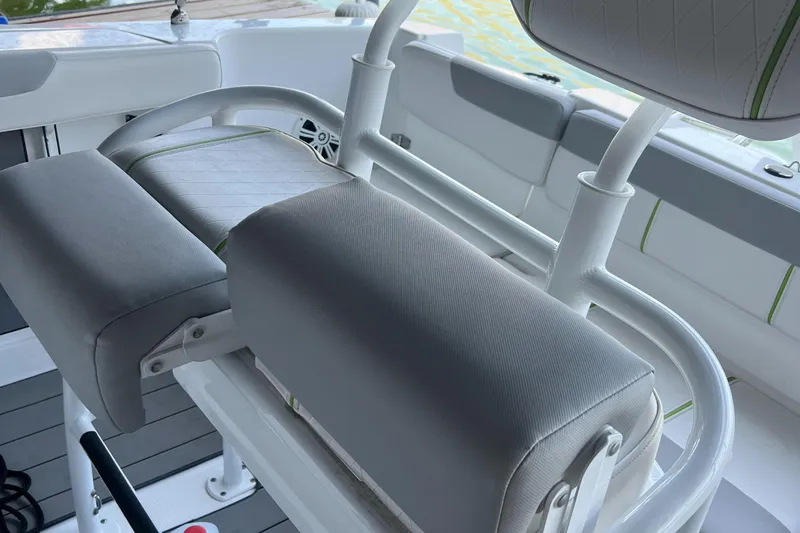 Slide: The Image of 2022 Tahoe 2150 CC boat interior with cushioned seating and white accents. - 16