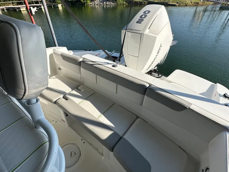 Slide: The Image of 2022 Tahoe 2150 CC boat interior with seating and outboard motor. - 21