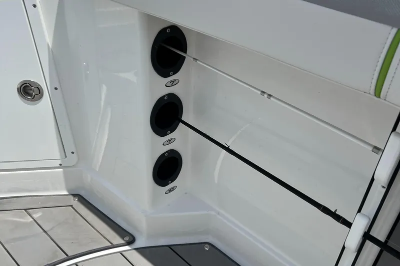 Slide: The Image of 2022 Tahoe 2150 CC boat rod holders and storage compartment. - 22