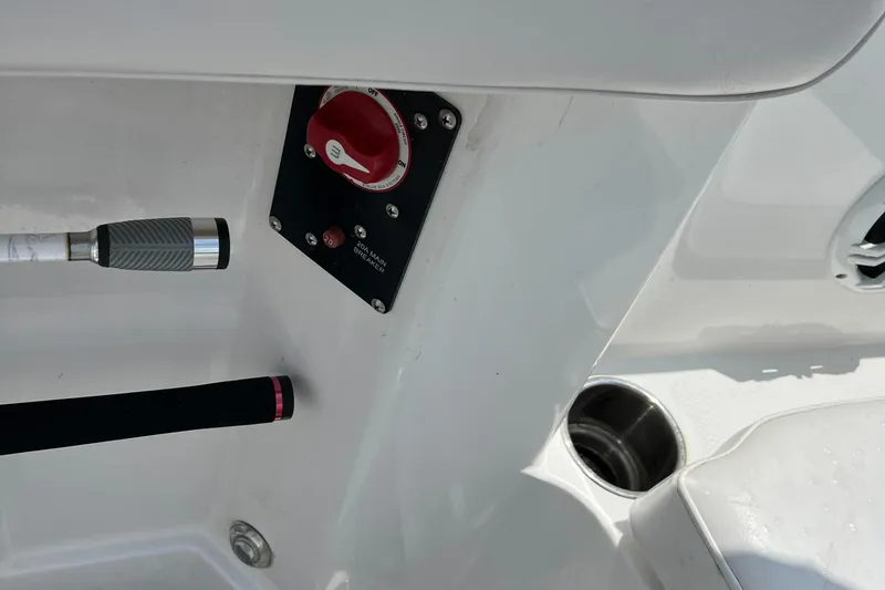 Slide: The Image of 2022 Tahoe 2150 CC boat control panel and cup holder. - 23
