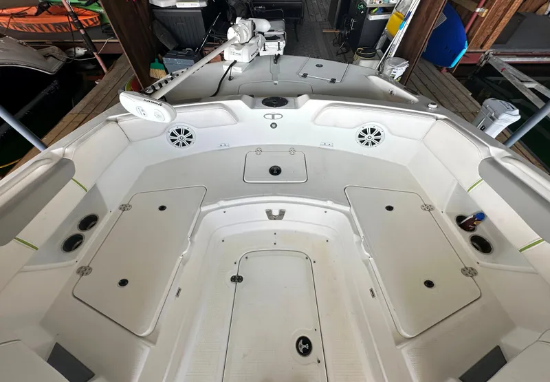 Slide: The Image of 2022 Tahoe 2150 CC boat interior with storage compartments and speakers. - 24