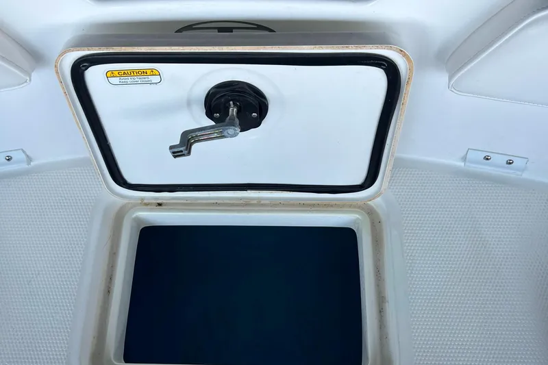 Slide: The Image of 2022 Tahoe 2150 CC boat storage compartment with open hatch. - 28