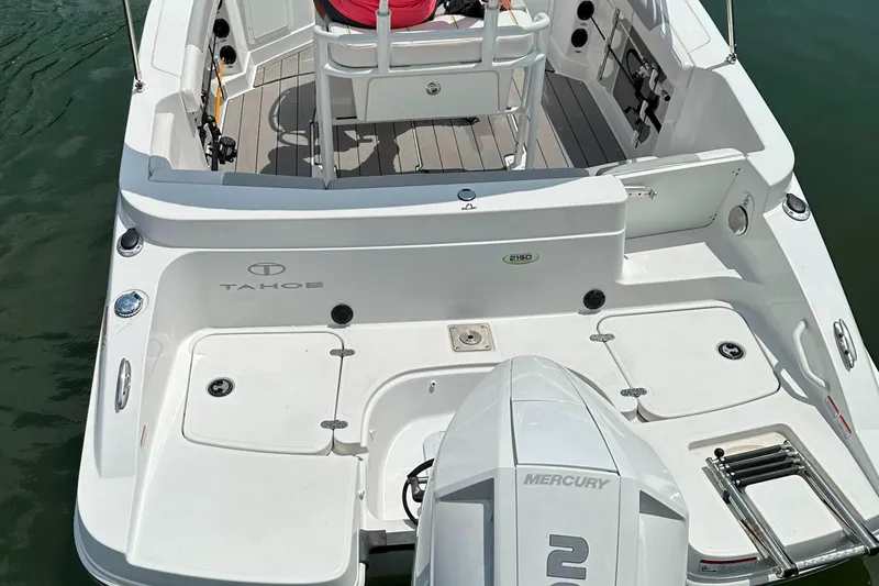 Slide: The Image of 2022 Tahoe 2150 CC boat with Mercury engine on water. - 4