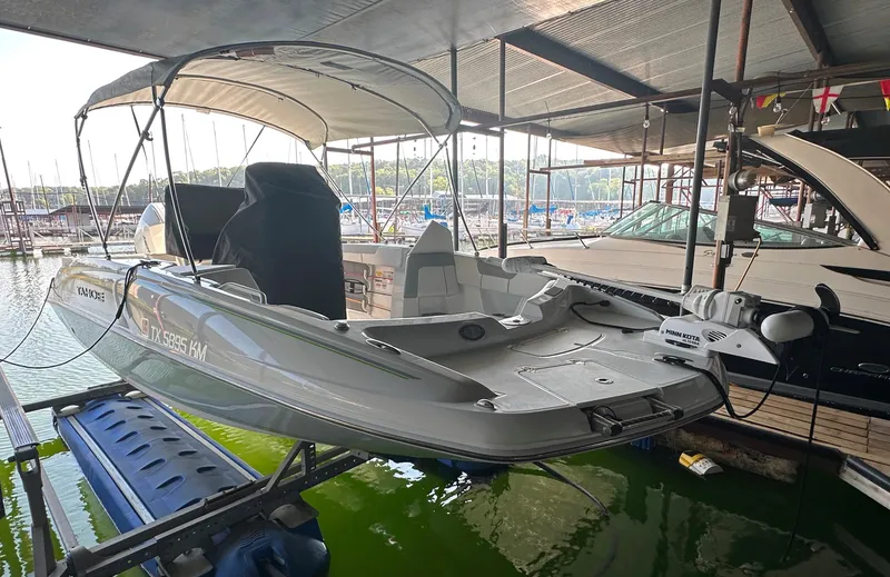 Slide: The Image of 2022 Tahoe 2150 CC boat docked in a marina. - 5