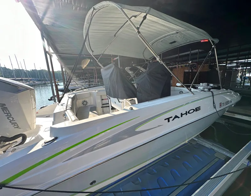 Slide: The Image of 2022 Tahoe 2150 CC boat docked under a canopy. - 6