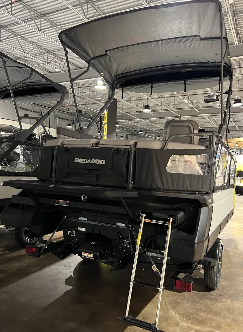 Slide: The Image of 2023 Sea-Doo SWITCH SPORT 18 230 pontoon boat with canopy and ladder in showroom. - 5