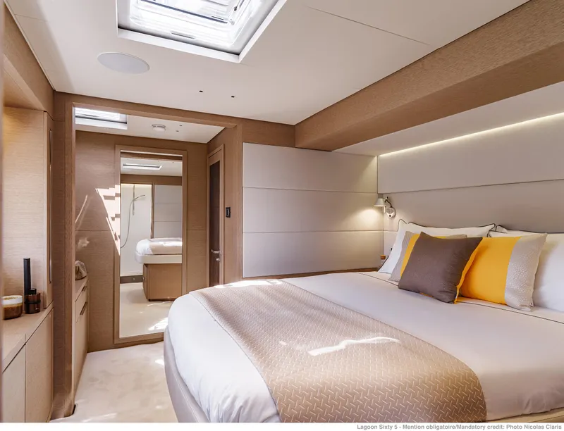Slide: The Image of Luxurious bedroom interior of 2025 Lagoon Sixty5 yacht with modern design and skylight. - 15