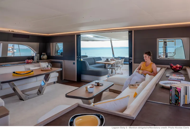 Slide: The Image of Luxurious Lagoon Sixty5 yacht interior, 2025 model, featuring elegant seating and ocean views. - 2